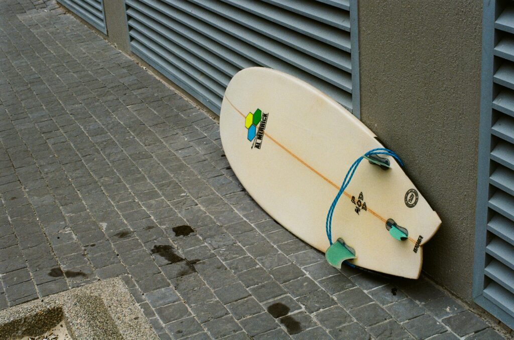 Surfboard with wet footprints on film by Ashlee Kovachi