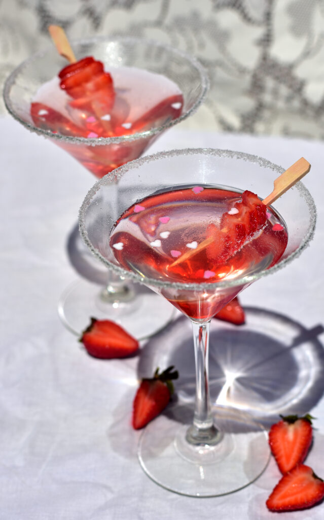 Photography of pink fizzy drinks with strawberries and hearts by Ashlee Kovachi 2022